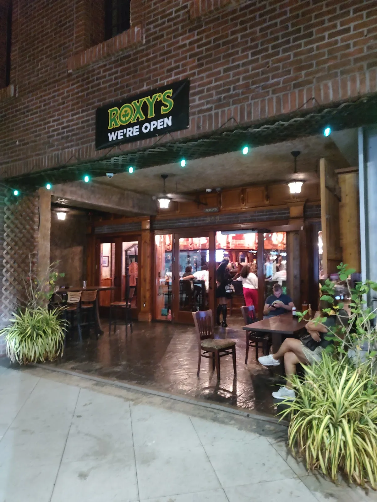 Roxy's Pub's rooftop terrace at night, overlooking Rooftop city views in Downtown, West Palm Beach.